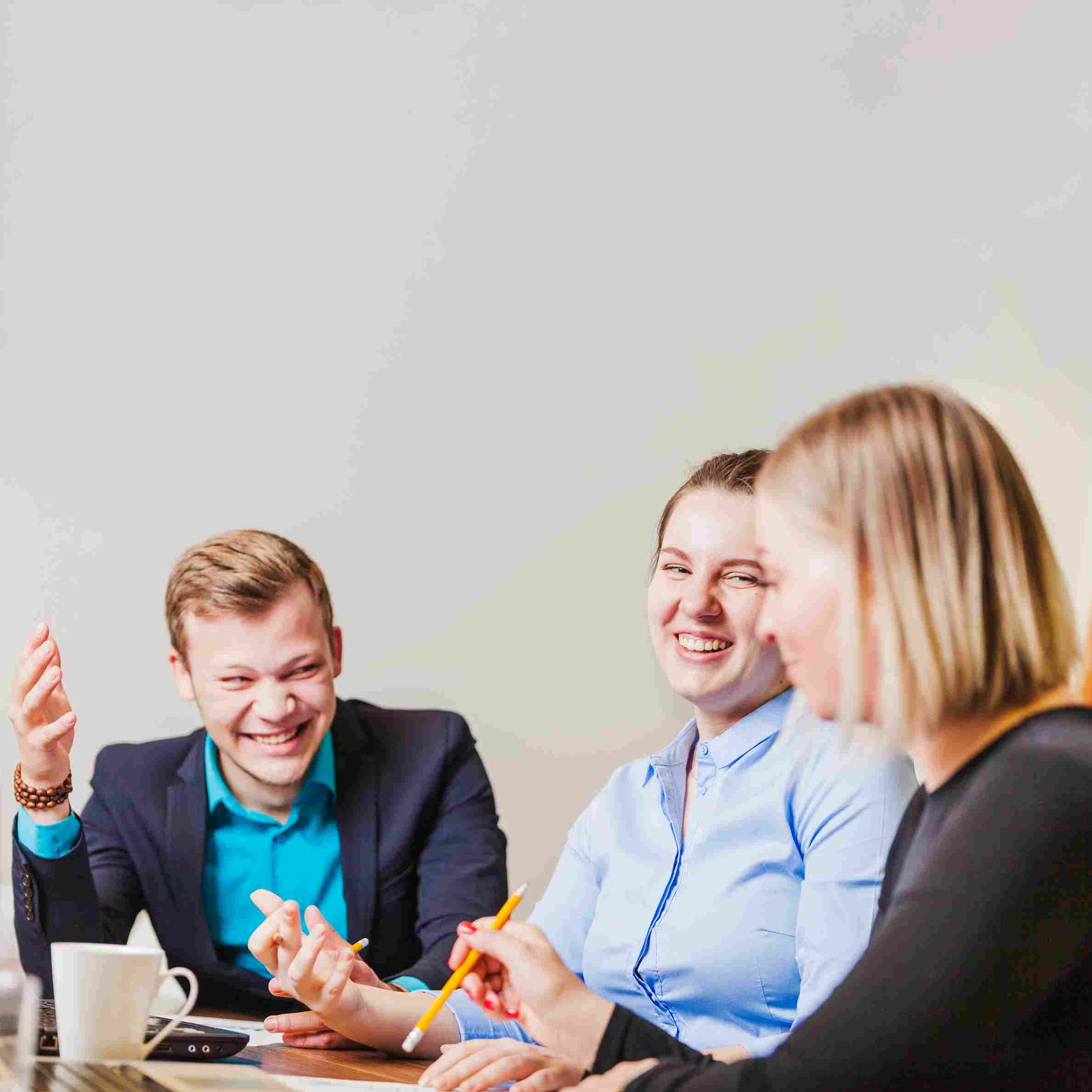 office-employees-sitting-desk-smiling_11zon